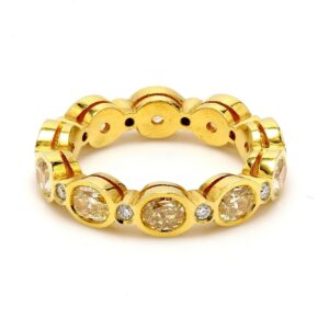 Eternity band in 18K YG with bezel set rounds & fancy yellow oval diamonds.  D3.13ct.t.w.  Fancy Yellow 2.98ct.t.w.